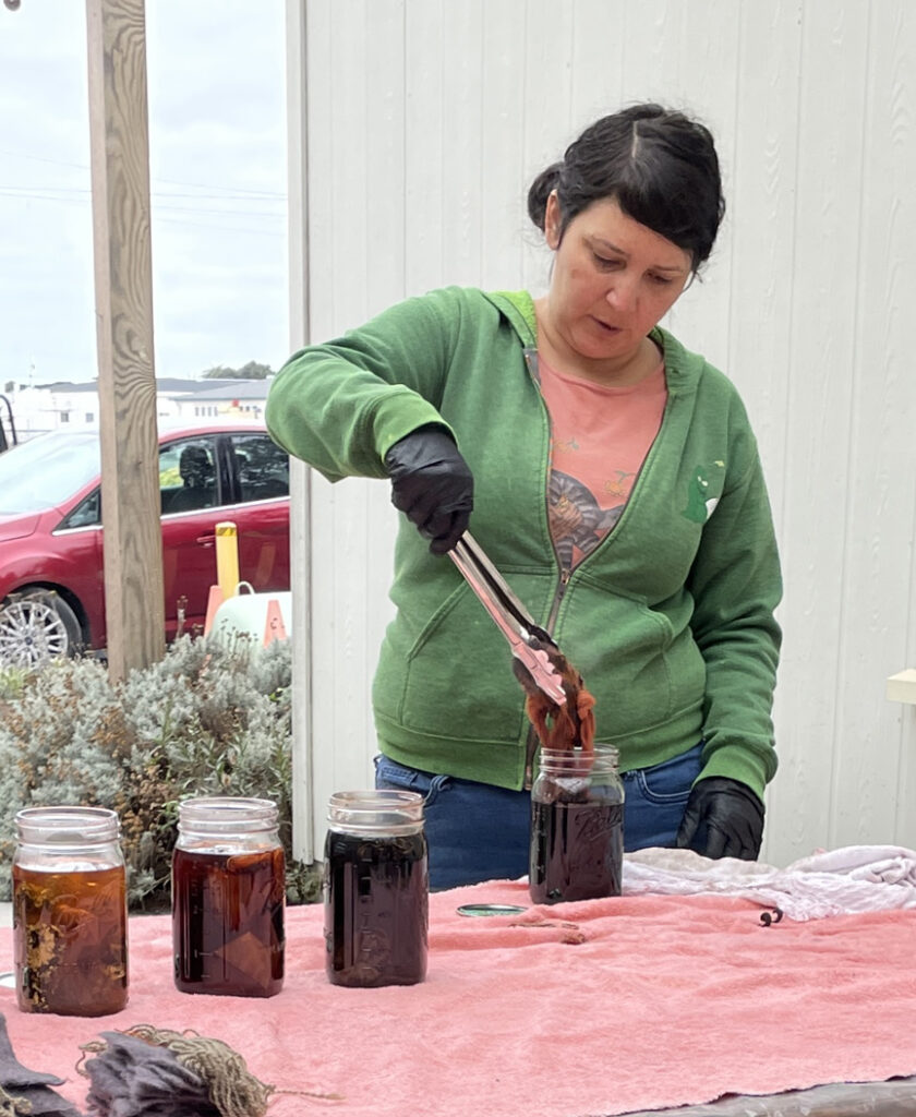 woman dyeing yarn sample