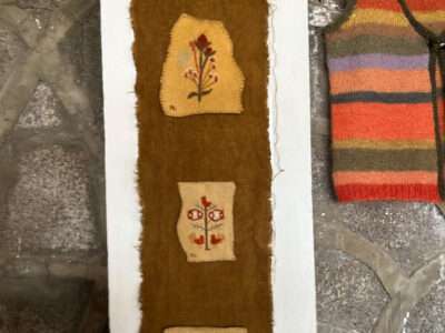 Embroidered hanging from IFFS 2025 exhibit