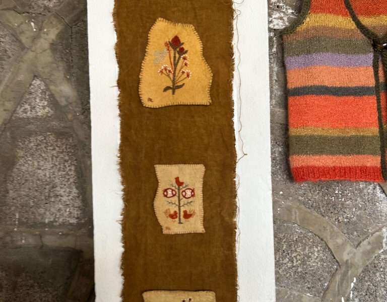 Embroidered hanging from IFFS 2025 exhibit