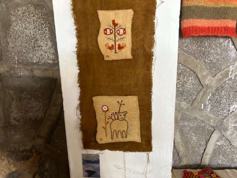 Embroidered hanging from IFFS 2025 exhibit
