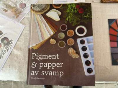 Seam rippers, boxes, and book from IFFS 2025 exhibit