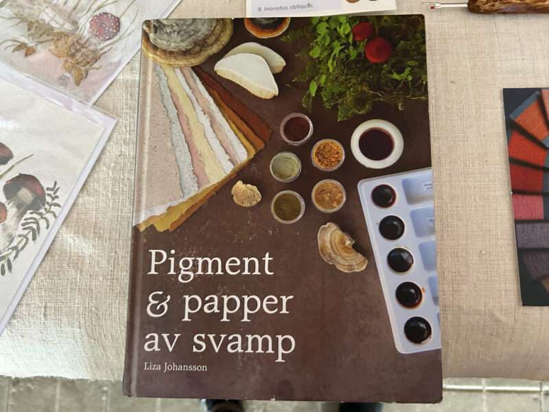 Seam rippers, boxes, and book from IFFS 2025 exhibit