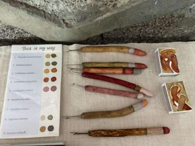 Seam rippers, boxes, and book from IFFS 2025 exhibit