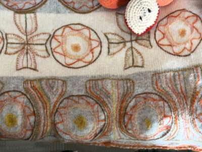 Embroidered sash from IFFS 2025 exhibit