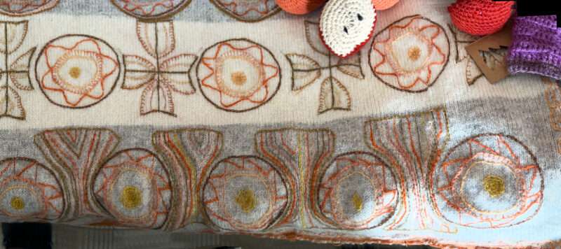 Embroidered sash from IFFS 2025 exhibit