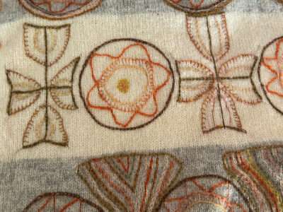 Embroidered sash from IFFS 2025 exhibit