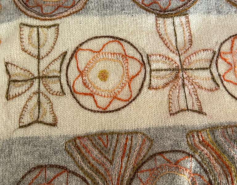 Embroidered sash from IFFS 2025 exhibit